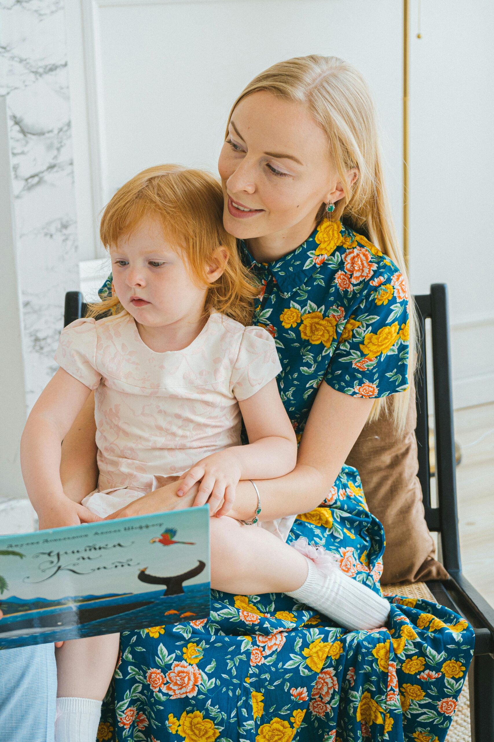 A mother and daughter read together, showcasing bonding and family time.
